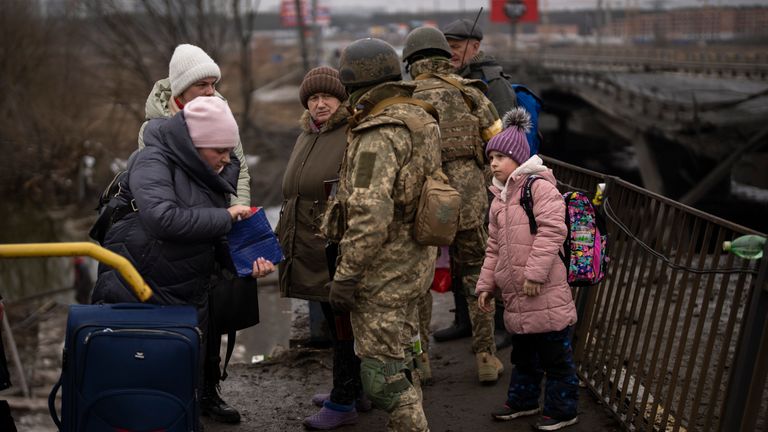 Ukrainian soldiers check people&#39;s identity cards as they flee their neighbourhoods, on the outskirts of Kyiv, Ukraine, Wednesday, March 2. 2022. (AP Photo/Emilio Morenatti)
PIC:AP

