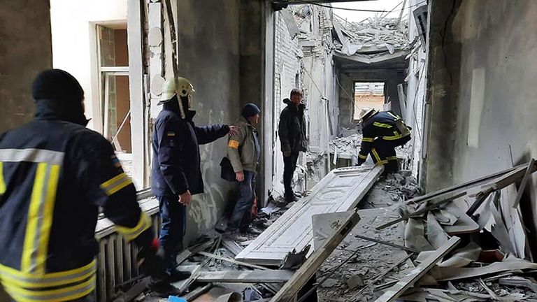 Ukrainian emergency workers work inside the damaged after shelling City Hall building in Kharkiv