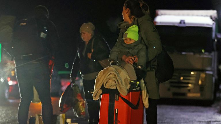 People aim for the Polish border in Lviv Oblast, western Ukraine, near 3 km before the Polish border, on February 27, 2022. Lots of Ukrainians are heading to Poland to escape the war. ( The Yomiuri Shimbun via AP Images )