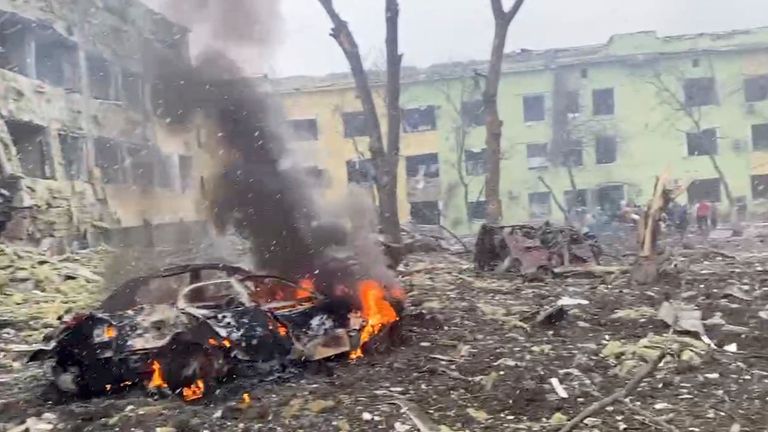 A car burns after the destruction of Mariupol children&#39;s hospital as Russia&#39;s invasion of Ukraine continues, in Mariupol, Ukraine, March 9, 2022 in this still image from a handout video obtained by Reuters. Ukraine Military/Handout via REUTERS THIS IMAGE HAS BEEN SUPPLIED BY A THIRD PARTY.
