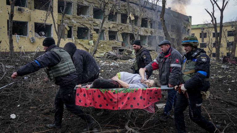 Ukrainian emergency workers and volunteers carry a wounded pregnant woman out of a maternity hospital who was injured by shelling in Mariupol, Ukraine, on Wednesday, March 9, 2022. (AP Photo / Evgeniy Maloletka) PIC: AP