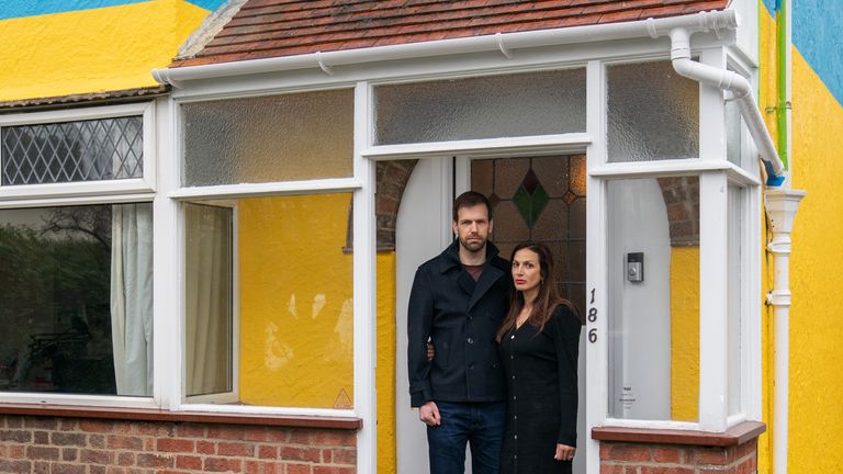 Rend Platings and her husband Michael outside their home in Cambridge, which they have painted in the colours of the Ukraine flag in a show of support for friends in the country. Picture date: Wednesday March 2, 2022.

