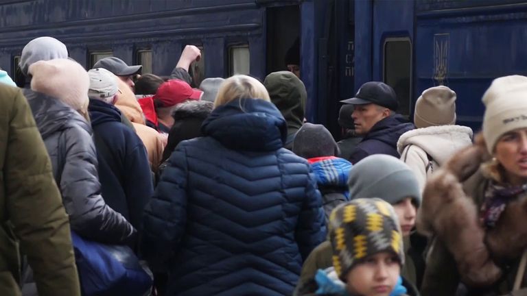 Ukrainians cram onto trains as they flee homes