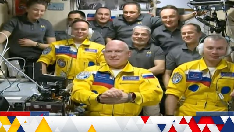 Russian cosmonauts Sergey Korsakov, Oleg Artemyev and Denis Matveyev during a welcome ceremony after arriving at the International Space Station, on Friday, wearing yellow flight suits in the colours of the Ukrainian flag