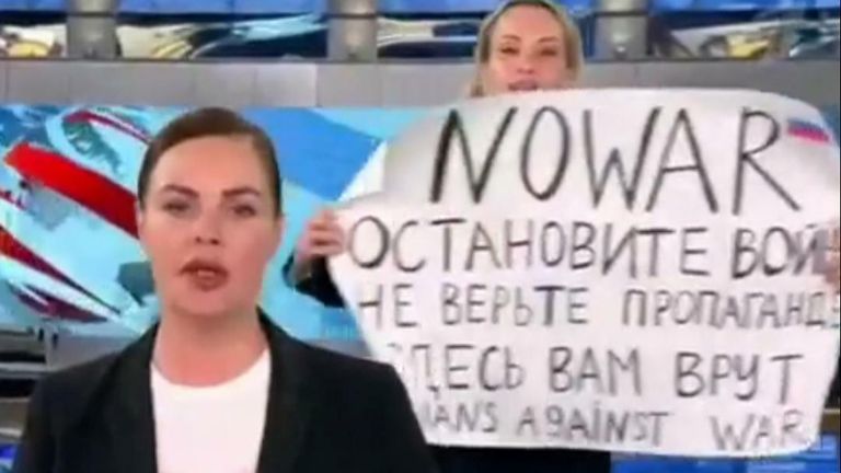 A protestor ran behind a news anchor to demonstrate against the Russian invasion of Ukraine. They said: &#34;Stop the war! No war!&#34;, and held a sign which said: &#34;NO WAR. Stop the war. Don&#39;t believe propaganda. They are lying to you. Russians against war.&#34;