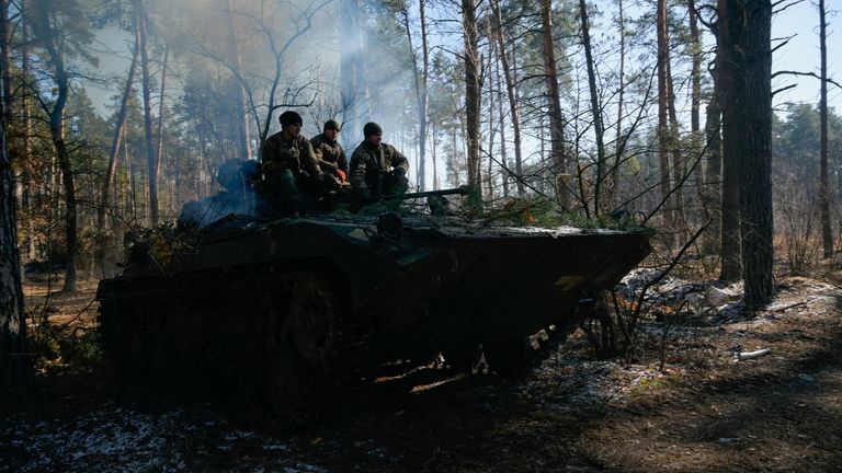 Members of the Ukrainian forces sit on a military vehicle amid Russia&#39;s invasion of Ukraine, near Demydiv, Ukraine March 10, 2022. REUTERS/Maksim Levin
