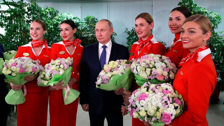 Russian President Vladimir Putin, center right, speaks to representatives of the flight crew of Russian airlines as he visits to Aeroflot Aviation School outside Moscow, Russia