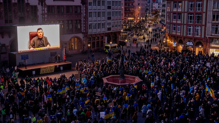 Ukrainian President Volodymyr Zelenskyy delivers a video message to people at a rally in Frankfurt, Germany