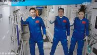 Three Chinese astronauts, from left, Ye Guangfu, Zhai Zhigang and Wang Yaping waving after entering the space station core module Tianhe in October 2021. Pic: Tian Dingyu/Xinhua via AP                                           