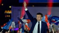 French President Emmanuel Macron waves on stage after being re-elected as president, following the results in the second round of the 2022 French presidential election, during his victory rally at the Champs de Mars in Paris, France, April 24, 2022. REUTERS/Gonzalo Fuentes

