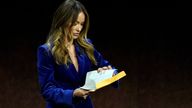 Olivia Wilde, director of the upcoming film "Don't Worry Darling," looks into an envelope handed to her onstage during the Warner Bros. Pictures presentation at CinemaCon 2022 at Caesars Palace, Tuesday, April 26, 2022, in Las Vegas. (AP Photo/Chris Pizzello) 