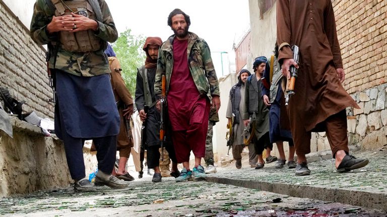 Taliban fighters stand guard on a blood-stained street at the site of an explosion in front of a school, in Kabul, Afghanistan, Tuesday, April 19, 2022. An Afghan police spokesman says explosions targeting educational institutions in Kabul have killed at least six civilians and injured over 10 others. Khalid Zadran said Tuesday the blasts occurred in the mostly-Shiite Muslim area in the west of Afghanistan&#39;s capital. (AP Photo/Ebrahim Noroozi)
