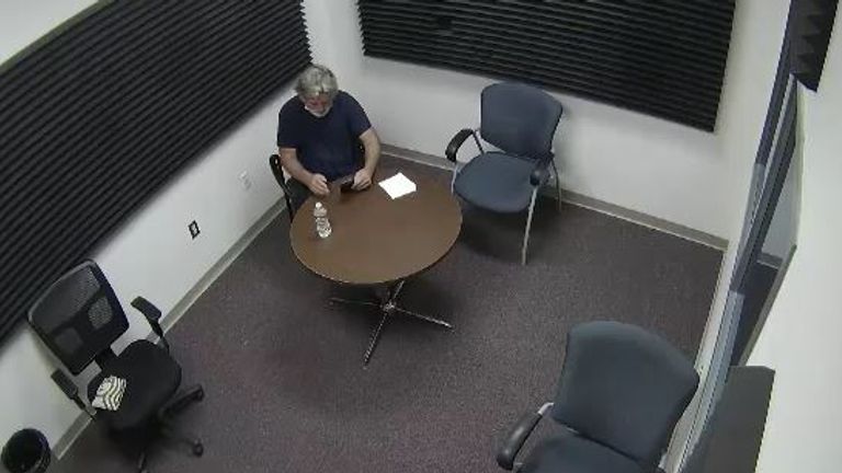 Alec Baldwin can be seen making phone calls as he waits for officers in a police interview room following the fatal shooting of cinematographer Halyna Hutchins on the set of his film Rust. Pic: Santa Fe County Sheriff&#39;s Office