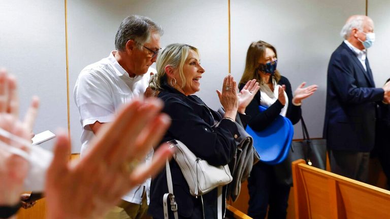 Cheryl Pangburn, center, and her brother Clint Bixler, children of victim Marilyn Bixler clap as they rejoice the verdict of serial killer Billy Chemirmir during the final day of his re-trial on Thursday, April 28, 2022 at Frank Crowley Courts Building in Dallas. He is found guilty of capital murder and will spend rest of his life in prison.