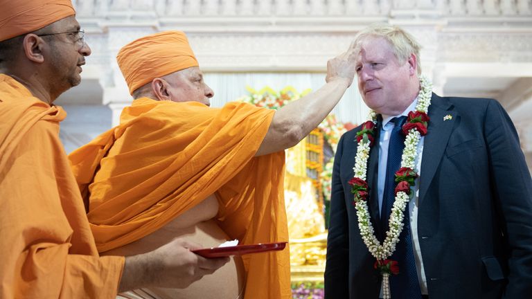 Prime Minister Boris Johnson has a tilak applied to his forehead by a senior sadhu as he visits the Swaminarayan Akshardham temple in Gandhinagar, Ahmedabad, as part of his two day trip to India. Picture date: Thursday April 21, 2022.
