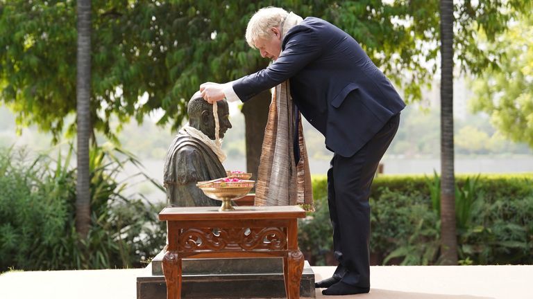 Prime Minister Boris Johnson places a garland around the neck of a statue of Mahatma Gandhi at his Sabarmati Ashram in Ahmedabad during a cultural tour as part of his two day visit to India. Picture date: Thursday April 21, 2022. PA Photo. Boris Johnson is expecting to seal new collaborations on defence and green energy in India as he seeks to reduce the country&#39;s dependence on Russian fossil fuels and military equipment. See PA story POLITICS India. Photo credit should read: Stefan Rousseau/PA Wire