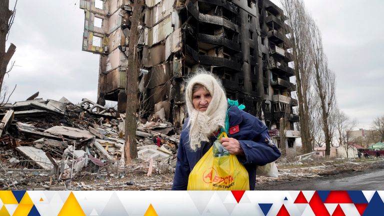 An elderly woman walks by an apartment building destroyed in the Russian shelling in Borodyanka, Ukraine, Wednesday, April 6, 2022. (AP Photo/Efrem Lukatsky)