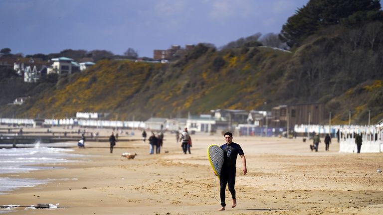 A surfer on the beach in Bournemouth this week