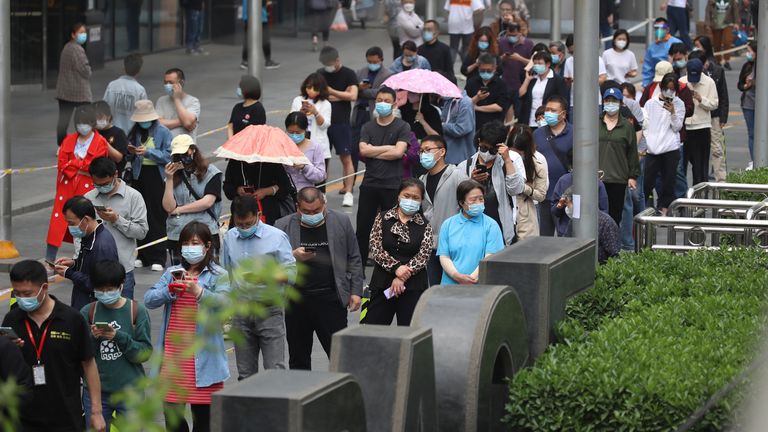 Local residents of Chaoyang District, Beijing Metropolitan area, wait in line to take PCR( polymerase chain reaction) test as a large number of Covid-19 infections has surged in China on April 25, 2022.  The Beijing Health Bureau has requested all 3.45 million residents and commuters to have mandatory PCR tests three times five days.  ( The Yomiuri Shimbun via AP Images )