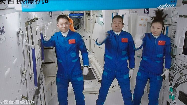 Three Chinese astronauts, from left, Ye Guangfu, Zhai Zhigang and Wang Yaping waving after entering the space station core module Tianhe in October 2021. Pic: Tian Dingyu/Xinhua via AP                                           