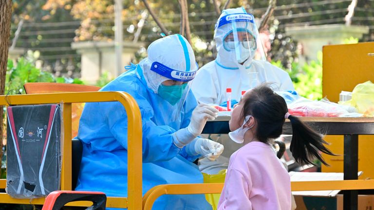 A little girl gets tested for the Covid-19 in a residential block in Shanghai, China Saturday, April 09, 2022. Pic: AP