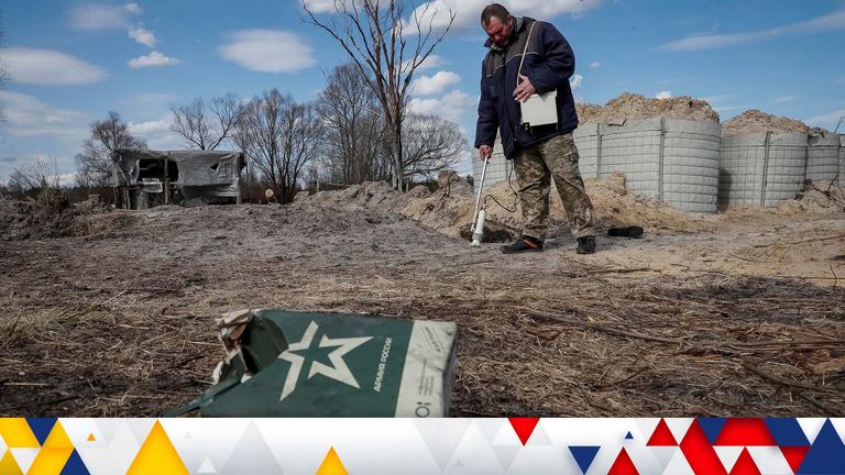 A dosimetrist measures the level of radiation around trenches dug by the Russian military in an area with high levels of radiation called the Red Forest, as Russia&#39;s attack on Ukraine continues, near the Chernobyl Nuclear Power Plant, in Chernobyl, Ukraine April 7, 2022. REUTERS/Gleb Garanich REFILE-CORRECTING SPELLING OF CITY