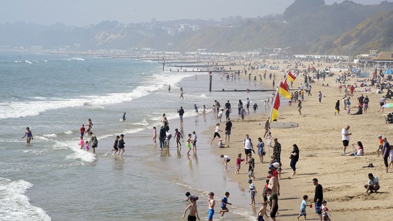 People enjoy the good weather at Bournemouth Beach in Dorset on Saturday
