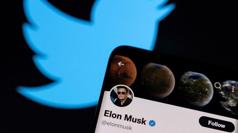 Elon Musk&#39;s twitter account is seen on a smartphone in front of the Twitter logo in this photo illustration taken, April 15, 2022. REUTERS/Dado Ruvic/Illustration
