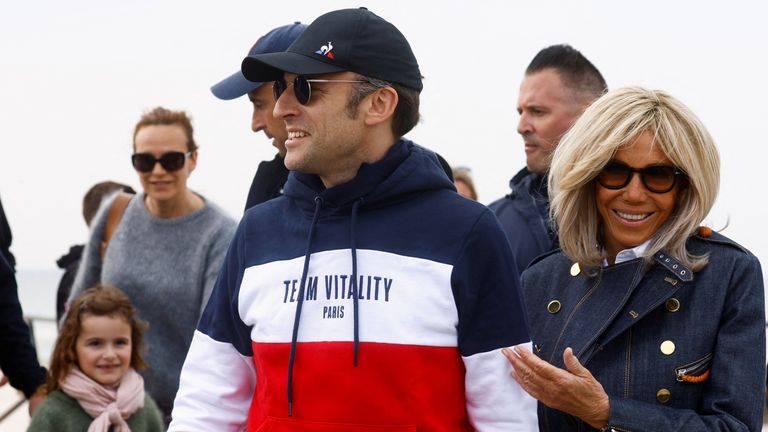 Macron greets people on the beach near his home in the northern seaside town of Le Touquet 