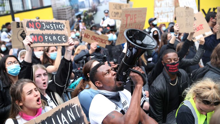 A demonstrator shouts through a megaphone outside the U.S. Embassy during a Black Lives Matter protest in London, following the death of George Floyd who died in police custody in Minneapolis, London, Britain, June 7, 2020. REUTERS/Hannah McKay