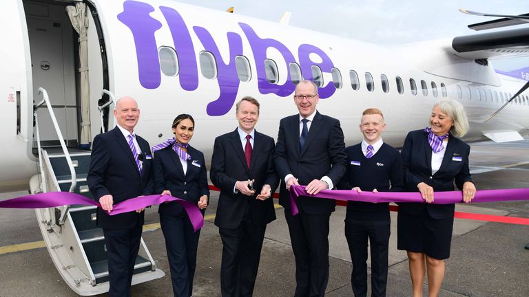 Flybe&#39;s first flight was marked by staff alongside chief executive Dave Pflieger (centre left) Birmingham Airport CEO Nick Barton