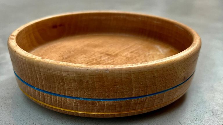 Undated family handout photo of a handmade wooden bowl etched with the colours of the Ukrainian flag made by 12-year Gabriel Clark, from Cumbria, who went viral online for his woodworking skills, and has raised over £66,000 for Ukrainian refugees after thousands of people entered a raffle to win one of his handmade bowls. Issue date: Wednesday April 6, 2022.
