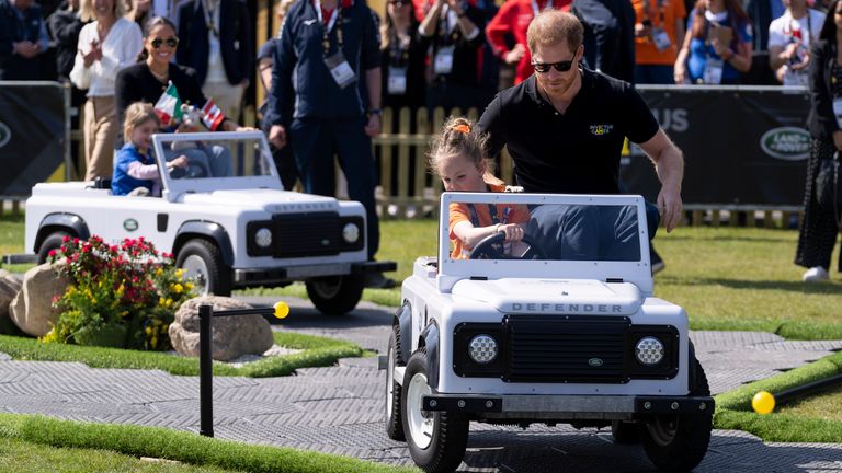 Prince Harry, right, and Meghan Markle, rear left, Duke and Duchess of Sussex, attend the Land Rover Driving Challenge at the Invictus Games venue in The Hague, Netherlands, Saturday, April 16, 2022. The week-long games for active servicemen and veterans who are ill, injured or wounded opens Saturday in this Dutch city that calls itself the global center of peace and justice. (AP Photo/Peter Dejong)


