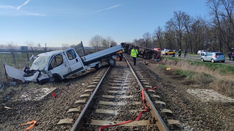 A derailed train and a pickup truck are seen at the scene of an accident where the pickup truck collided with the train in Mindszent, Hungary, April 5, 2022. Firefighter Lieutenant Krisztina Molnar / Handout via REUTERS THIS Image has been provided AT A THIRD PARTY. FREE CREDIT. NO RESALES. NO ARCHIVE.
