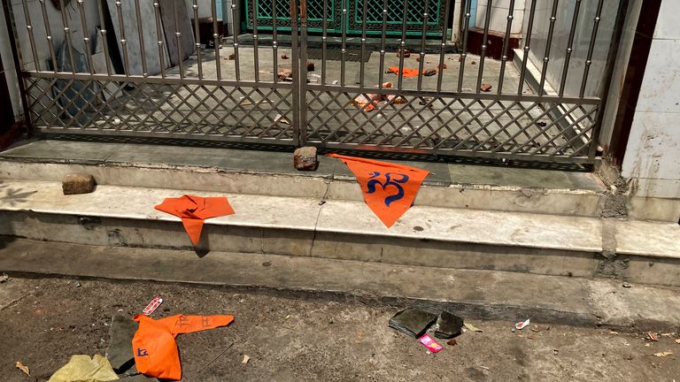 Saffron flags lie outside a mosque a day after communal clashes in Jahangirpuri, a neighborhood in northwest Delhi, Sunday, April 17, 2022. Police in India&#39;s capital have arrested 14 people after communal violence broke out during a Hindu religious procession, leaving several injured. The suspects were arrested on charges of rioting and criminal conspiracy, among others, according to local media reports Sunday. (AP Photo/Rishi Lekhi)


