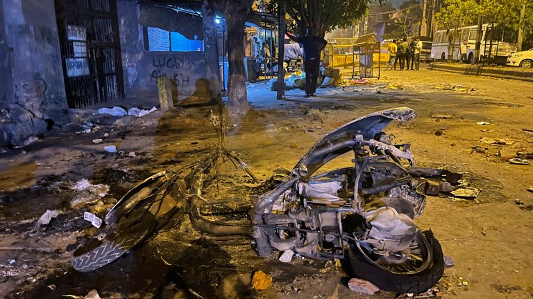 Burnt remains of a motorcycle lie in a street after communal violence in New Delhi, India, Sunday, April 17, 2022. Police in India&#39;s capital have arrested 14 people after communal violence broke out during a Hindu religious procession, leaving several injured. The suspects were arrested on charges of rioting and criminal conspiracy, among others, according to local media reports Sunday. (AP Photo/Arbab Ali)


