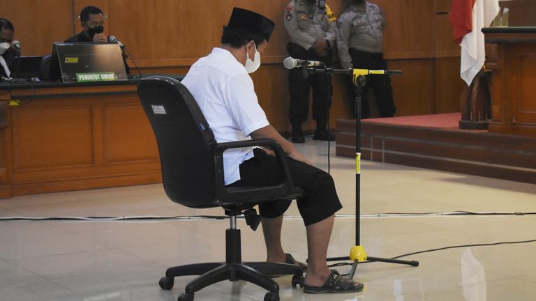 Herry Wirawan, the principal of a girls-only Islamic boarding school who is accused of raping his students, sits on the defendant...s chair during his sentencing hearing at a district court in Bandung, West java, Indonesia, Tuesday, Feb. 15, 2022. The court sentenced Wirawan to life in prison for raping at least 13 students between the ages of 11 and 14 and impregnating some of them. (AP Photo/Rafi Fadh).