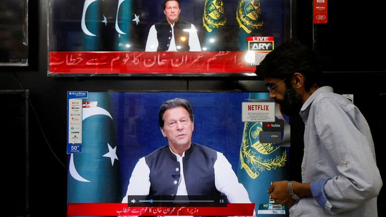 A shopkeeper tunes a television screen to watch the speech of Pakistani Prime Minister Imran Khan, at his shop in Islamabad, Pakistan, March 31, 2022. REUTERS/Akhtar Soomro