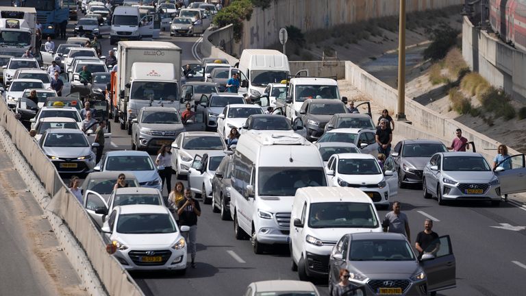 Israelis stand next to their cars as a two-minute siren sounds in memory of victims of the Holocaust in Tel Aviv. Pic: AP