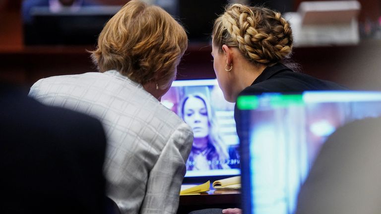 Amber Heard watches virtual testimony from her former PA during the libel trial brought by her ex Johnny Depp