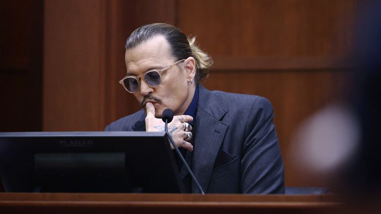 US actor Johnny Depp listens as he testifies during the 50 million US dollar Depp vs Heard defamation trial at the Fairfax County Circuit Court in Fairfax, Virginia, U.S., April 21, 2022. Jim Lo Scalzo/Pool via REUTERS
