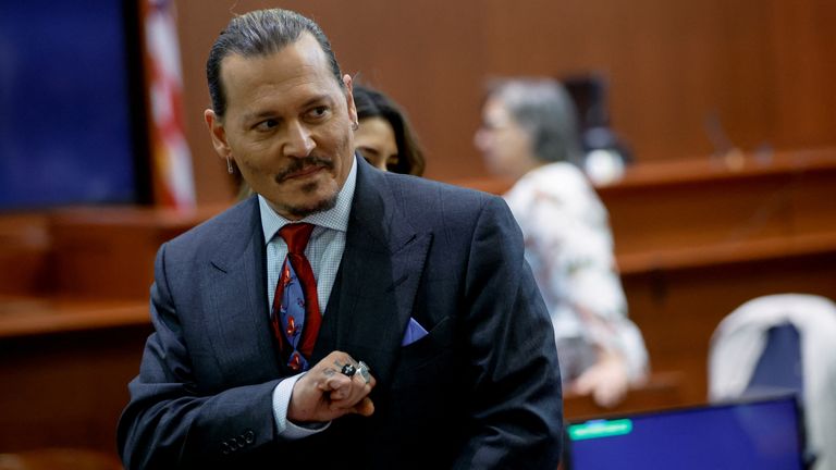 Actor Johnny Depp gestures as he stands in the courtroom during a recess amid his defamation trial against his ex-wife Amber Heard, at the Fairfax County Circuit Courthouse in Fairfax, Virginia, U.S., April 27, 2022. REUTERS/Jonathan Ernst/Pool
