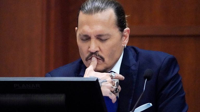 Actor Johnny Depp reacts as he testifies in the courtroom during the defamation trial against ex-wife Amber Heard at the Fairfax County Circuit Courthouse in Fairfax, Virginia, U.S., April 25, 2022. Steve Helber/Pool via REUTERS
