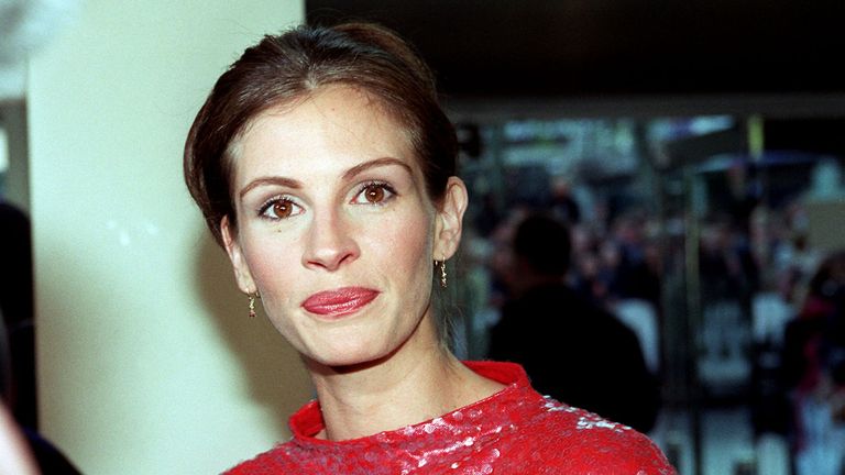 American film star Julia Roberts arriving for the World Premiere of "Notting Hill", in which she stars with Hugh Grant at the Odeon Leicester Square, London. She is wearing a dress designed by Vivien Tam.
