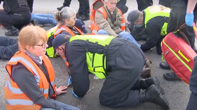 Protesters glued their hands to the floor as part of their disruption 