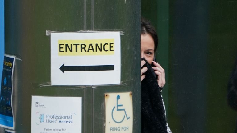 Ex-EastEnders actor Katie Jarvis stands behind a pillar as she waits to enter Basildon Combined Court where she denies racially aggravated harassment, common assault and two counts of assault by beating. The four charges relate to an alleged incident in Southend on July 31 2020. Picture date: Tuesday April 19, 2022.
