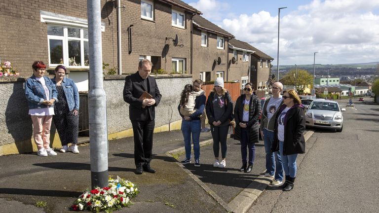 Fr Jospeh Gormley says prayers with family and friends of Lyra McKee after laying wreaths at the spot where she was killed