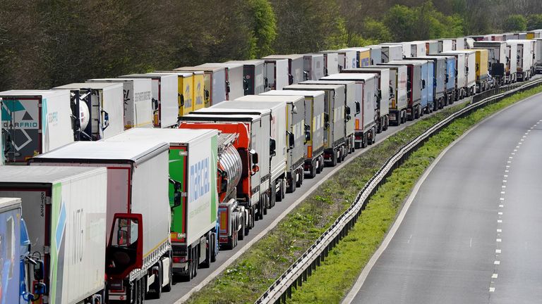 A man stands amongst lorries queued in Operation Brock on the M20 near Ashford in Kent as freight delays continue at the Port of Dover, in Kent, where P&O ferry services remain suspended after the company sacked 800 workers without notice. Picture date: Thursday April 7, 2022.
