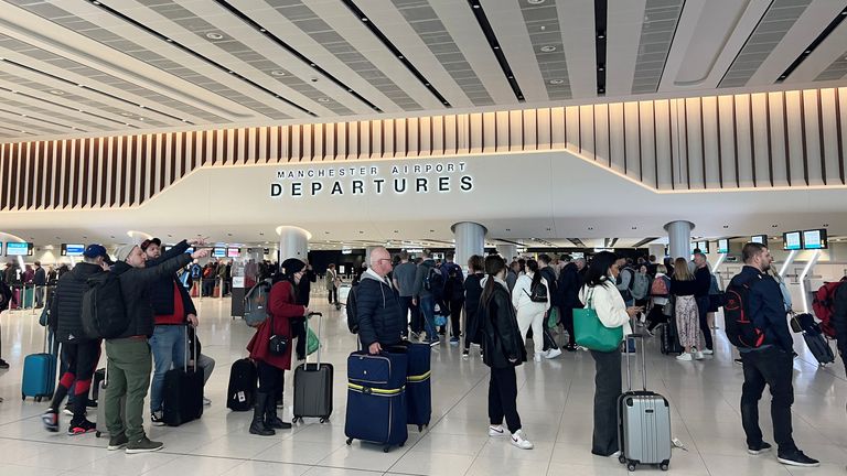 Yolcular, İngiltere, Manchester'daki Manchester Havalimanı'ndaki Terminal 2'nin yolcu bölümünde güvenlik taraması için sıraya girdi. 4 Nisan 2022. REUTERS/Phil Noble