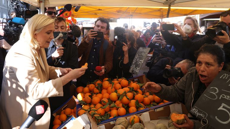 Marine Le Pen, French far-right National Rally (Rassemblement National) party candidate for the 2022 French presidential election, visits a local market in Etaples on the last day of campaigning, ahead of the second round of the presidential election, France, April 22, 2022. REUTERS/Yves Herman

